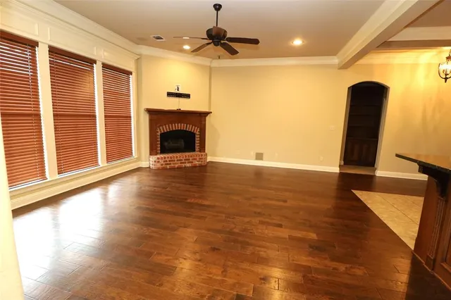 a view of a livingroom with a fireplace and window