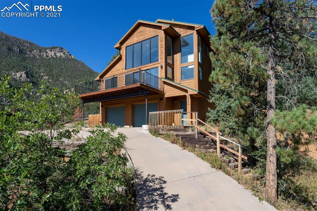 a front view of a house with a garden