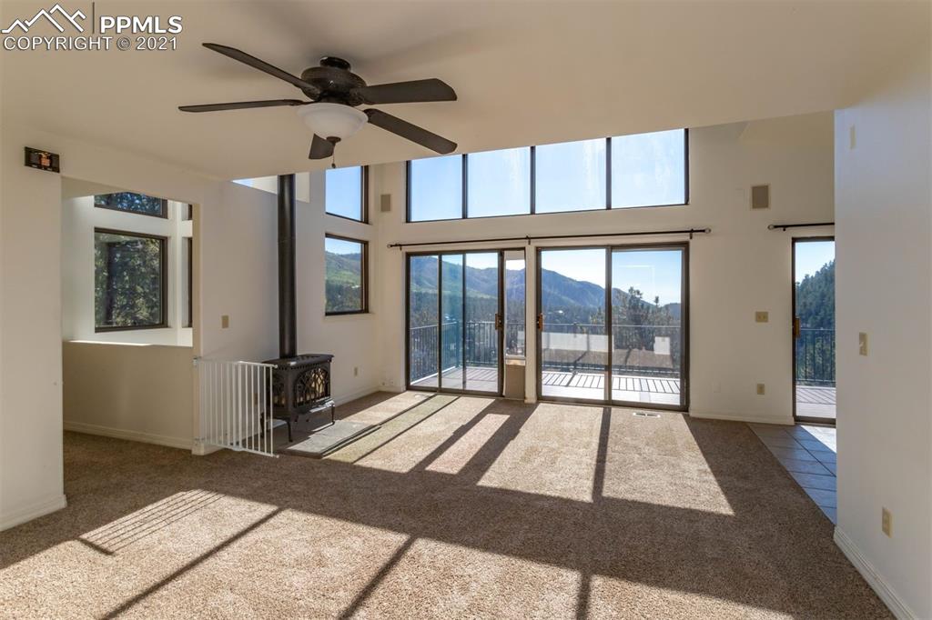 4440 Prairie Street Cascade, CO 80809 - Photo 17 of 38 a spacious bedroom with a large bed and a large window