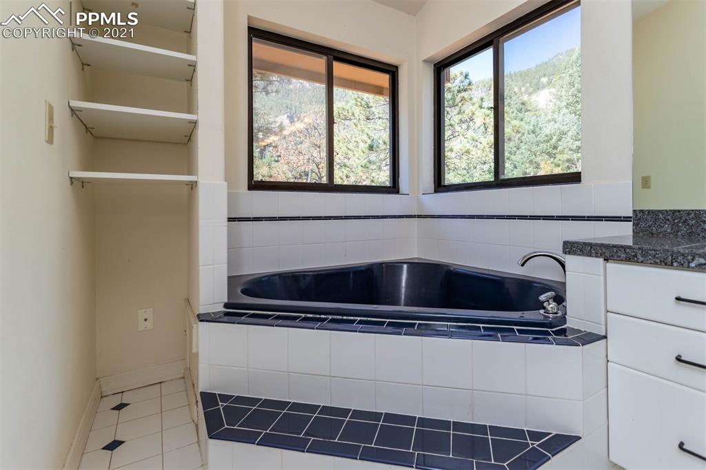 4440 Prairie Street Cascade, CO 80809 - Photo 24 of 38 a kitchen with a sink a window and cabinets