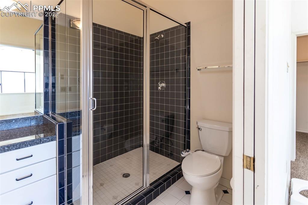 4440 Prairie Street Cascade, CO 80809 - Photo 25 of 38 a bathroom with a shower toilet and sink