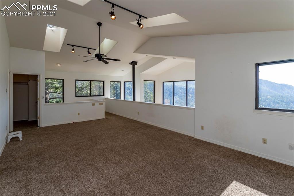 4440 Prairie Street Cascade, CO 80809 - Photo 26 of 38 an empty room with windows and ceiling fan