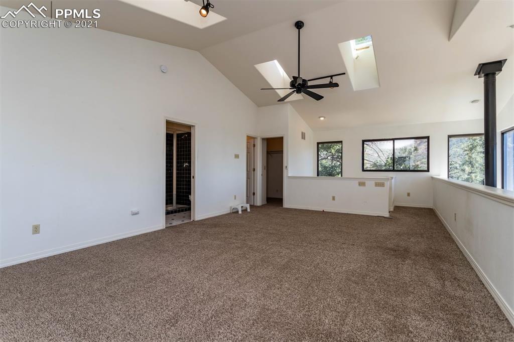 4440 Prairie Street Cascade, CO 80809 - Photo 27 of 38 en empty room with windows and ceiling fan