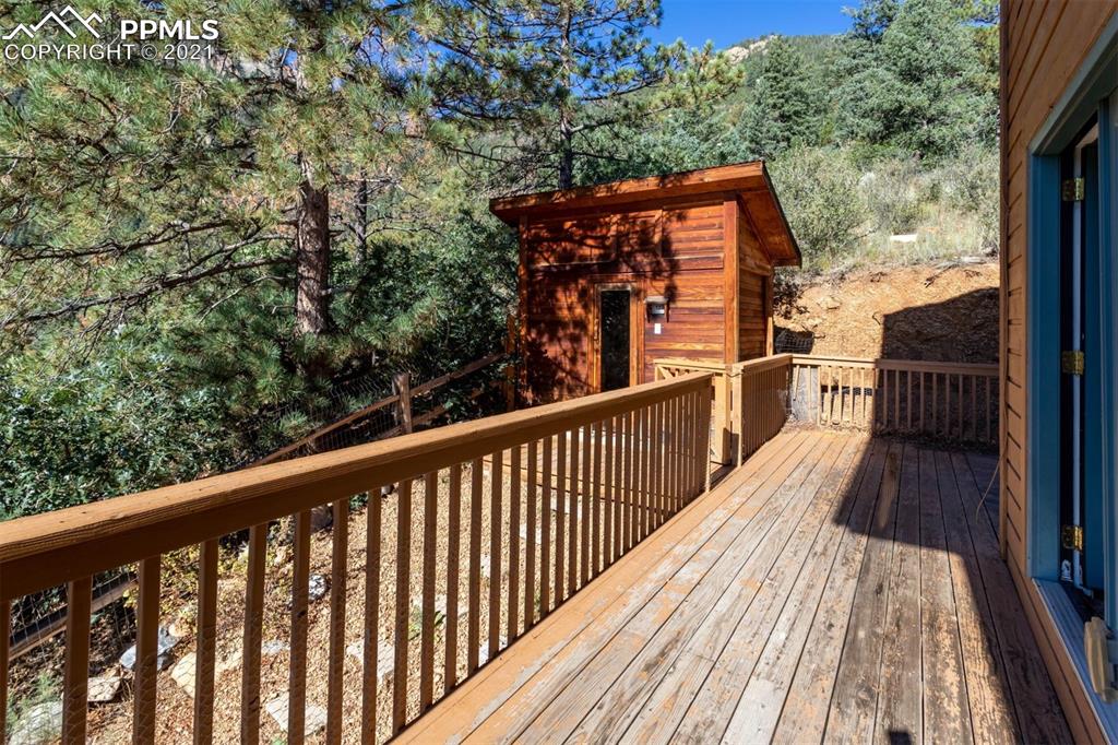 4440 Prairie Street Cascade, CO 80809 - Photo 4 of 38 a view of balcony with wooden floor and fence