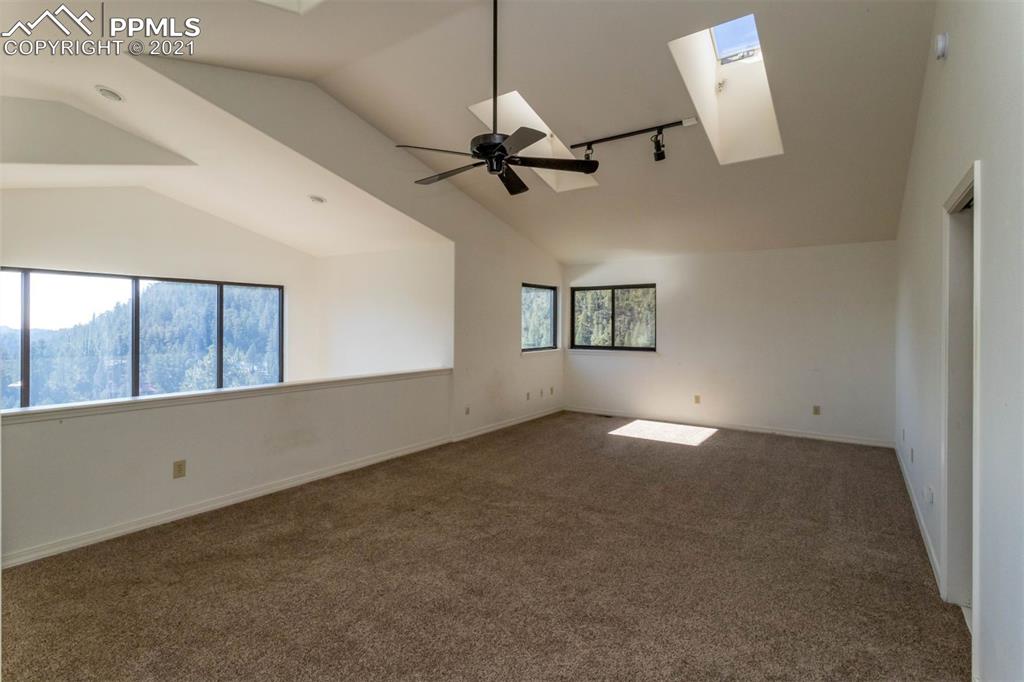 4440 Prairie Street Cascade, CO 80809 - Photo 31 of 38 an empty room with windows and fan