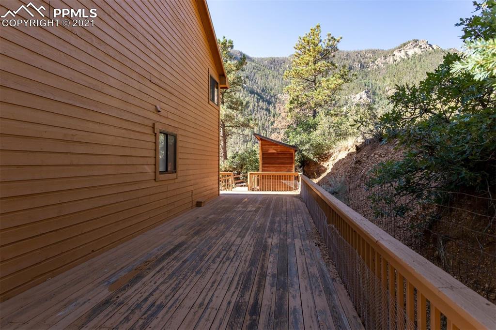 4440 Prairie Street Cascade, CO 80809 - Photo 6 of 38 a balcony with wooden floor and trees