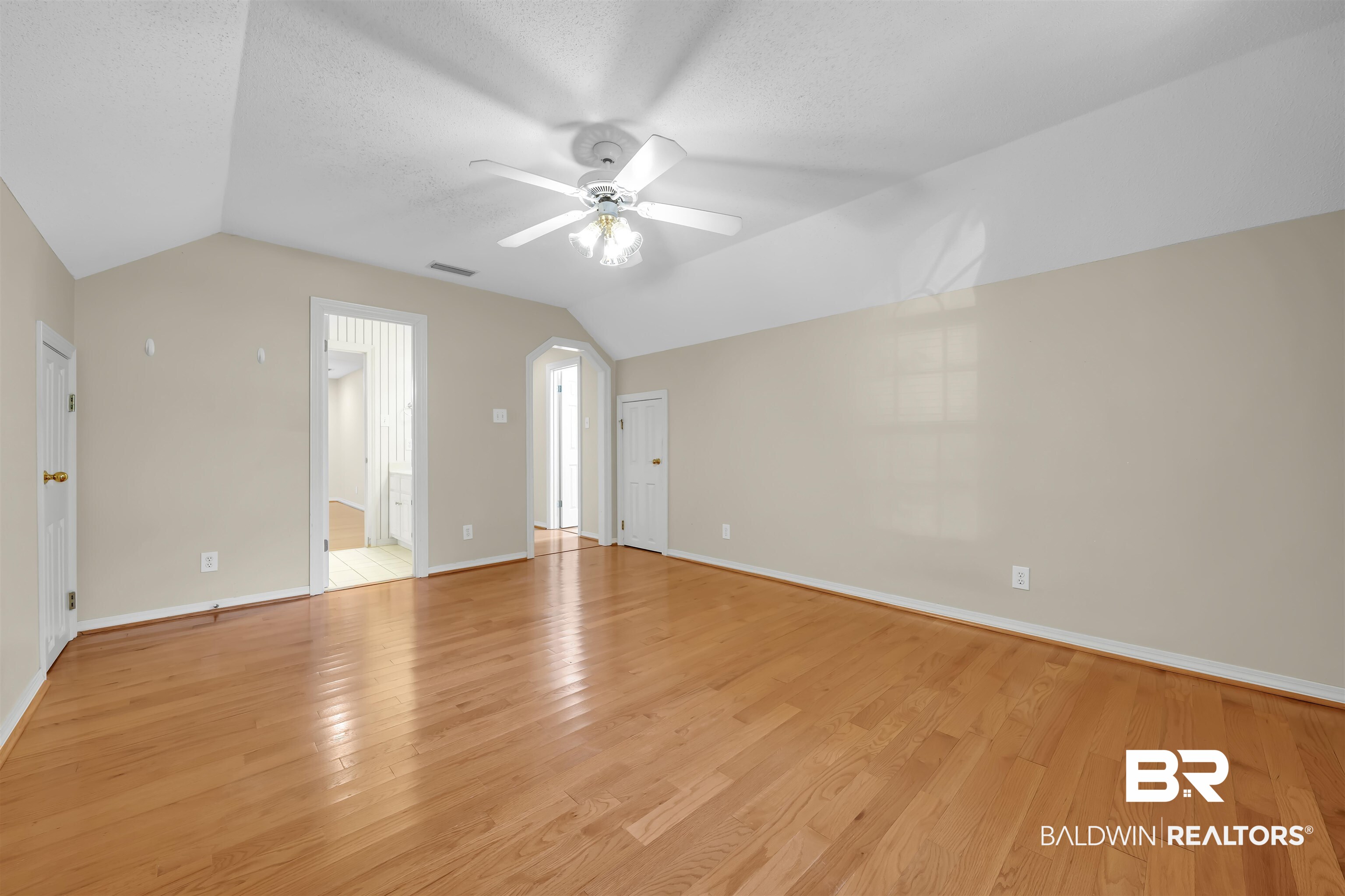 1262 Patrick Street Daphne, AL 36526 - Photo 25 of 35 Spare room with lofted ceiling, light wood-style flooring, a ceiling fan, and a textured ceiling