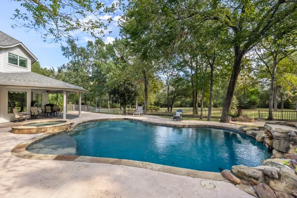 a view of a house with pool and sitting area