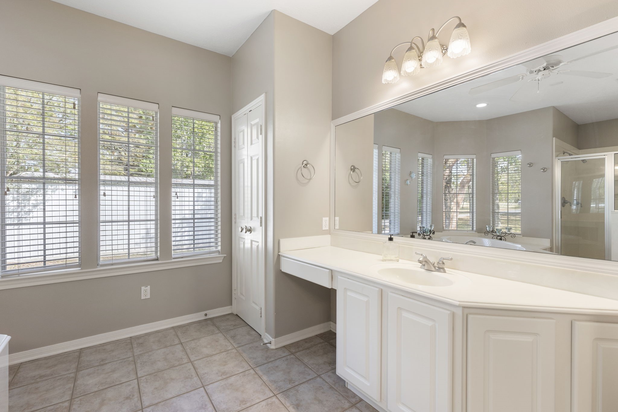 20111 Hilltop Ranch Drive Montgomery, TX 77316 - Photo 23 of 32 a bathroom with a sink vanity and a mirror