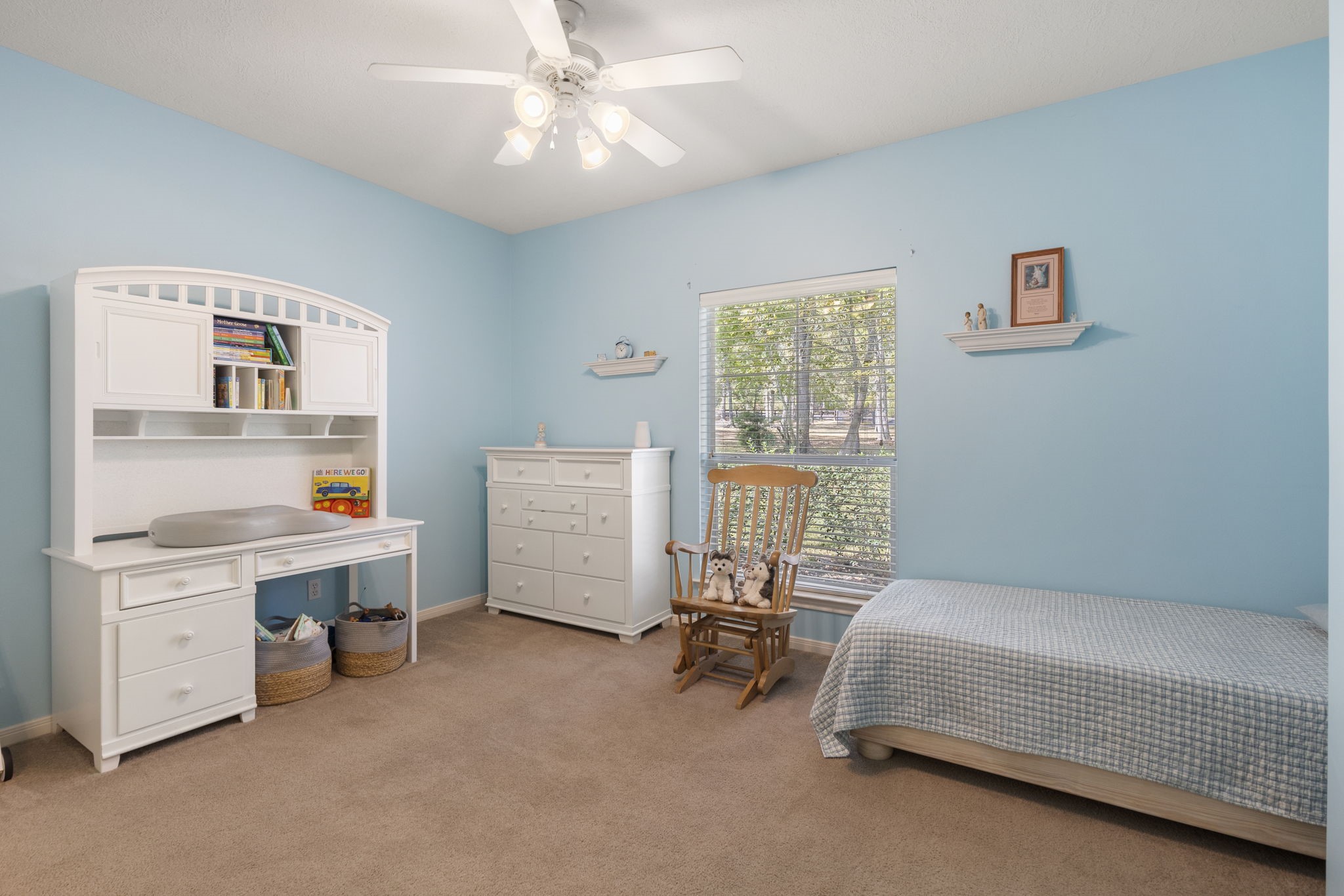 20111 Hilltop Ranch Drive Montgomery, TX 77316 - Photo 26 of 32 a bedroom with a bed and a chandelier