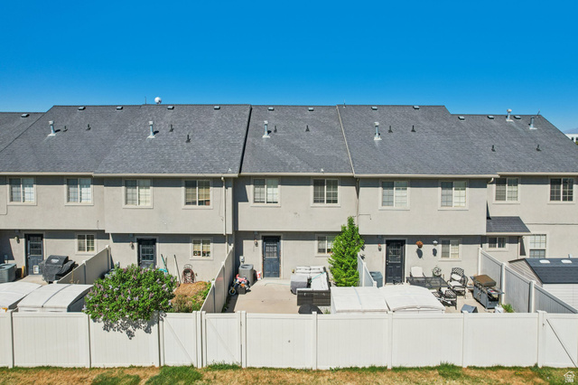 1077 South 1850th Street West Springville, UT 84663 - Photo 22 of 22 Rear view of property with stucco siding and a gate