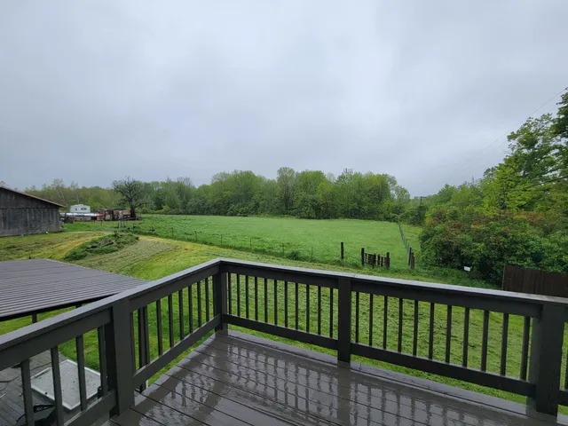 a balcony with trees in the back