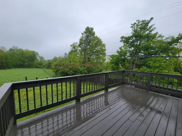 a balcony with wooden floor and fence