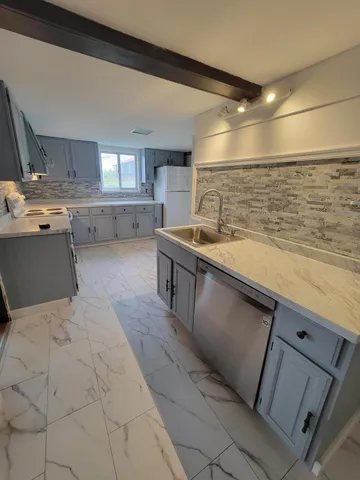 a kitchen with a sink and cabinets