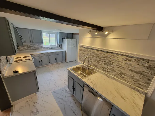 a bathroom with a sink a toilet and mirror