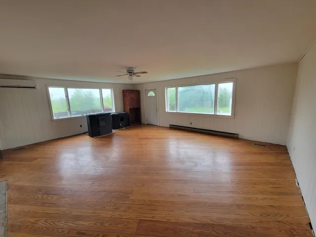 a view of a livingroom with wooden floor and window