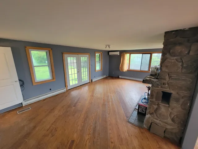 wooden floor in an empty room with a window