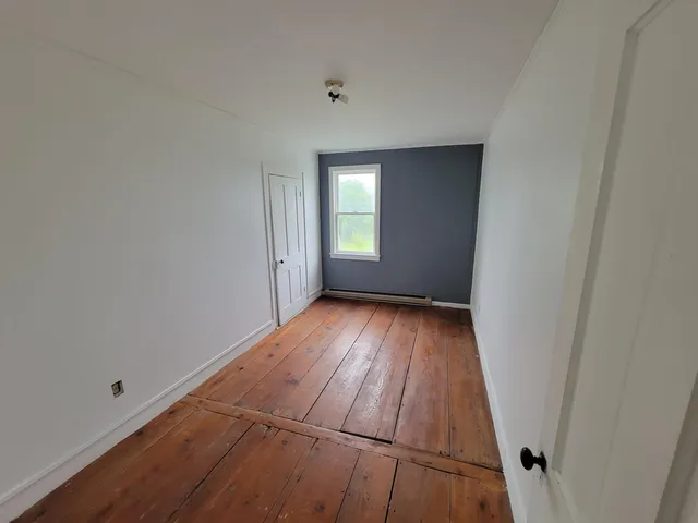 wooden floor in a hall with an empty room