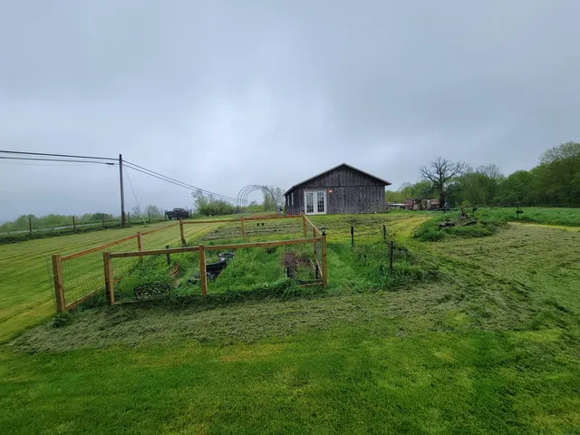a view of a house with a yard and sitting area