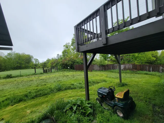 a backyard of a house with table and chairs