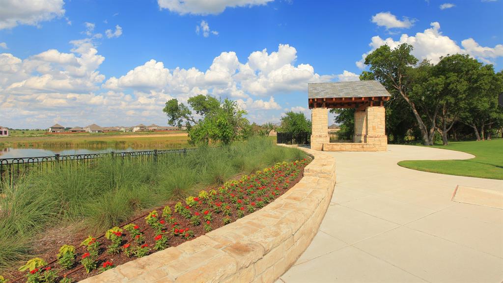 2933 Soaring Hls Drive Forney, TX 75126 - Photo 10 of 14 a view of a lake with a house in the background