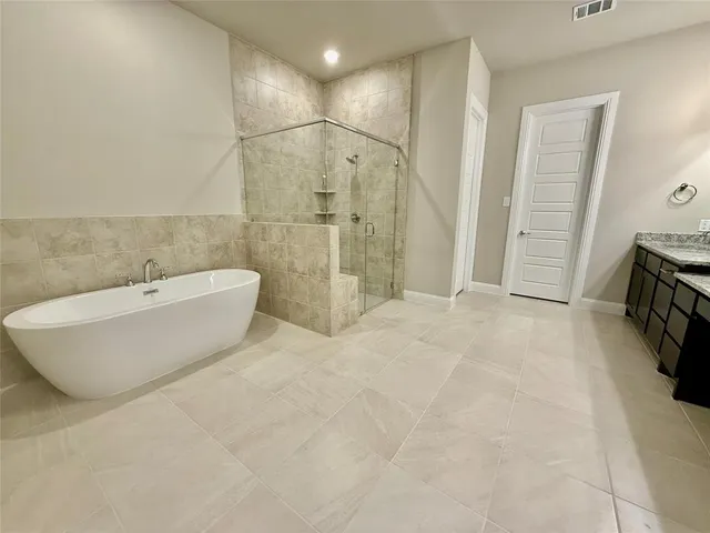 a spacious bathroom with a granite countertop sink a mirror and a shower
