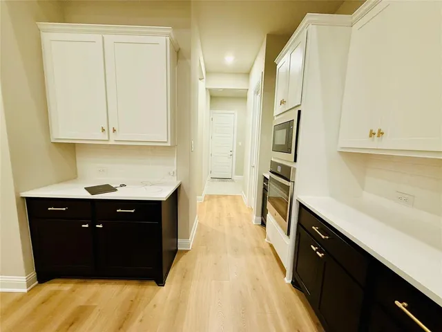 a spacious bathroom with a sink and a mirror