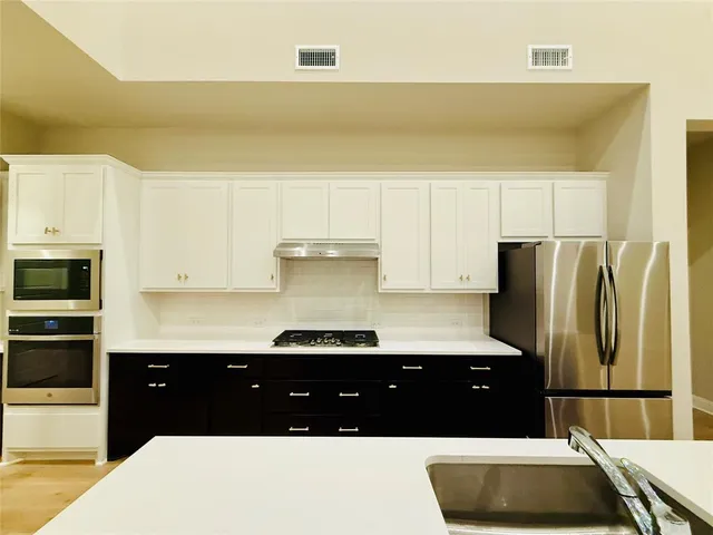 a kitchen with a sink and refrigerator