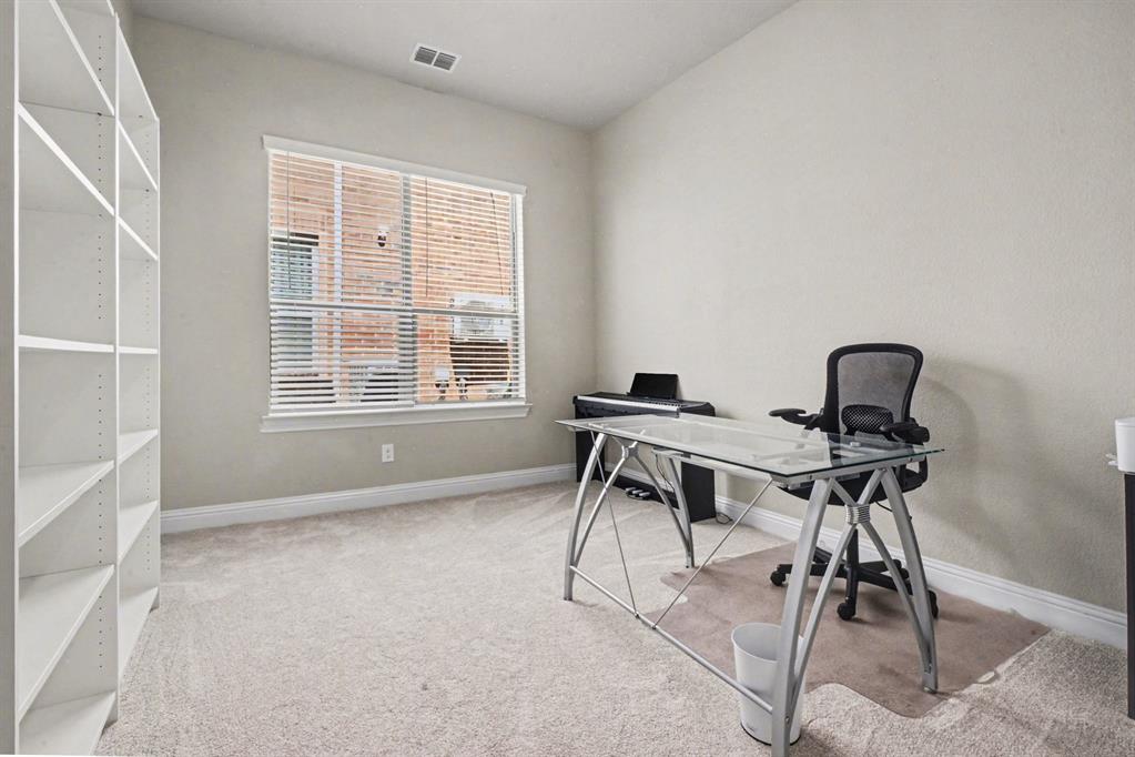 3323 Royal Ridge Drive Rockwall, TX 75087 - Photo 13 of 37 a view of a workspace with furniture and a window