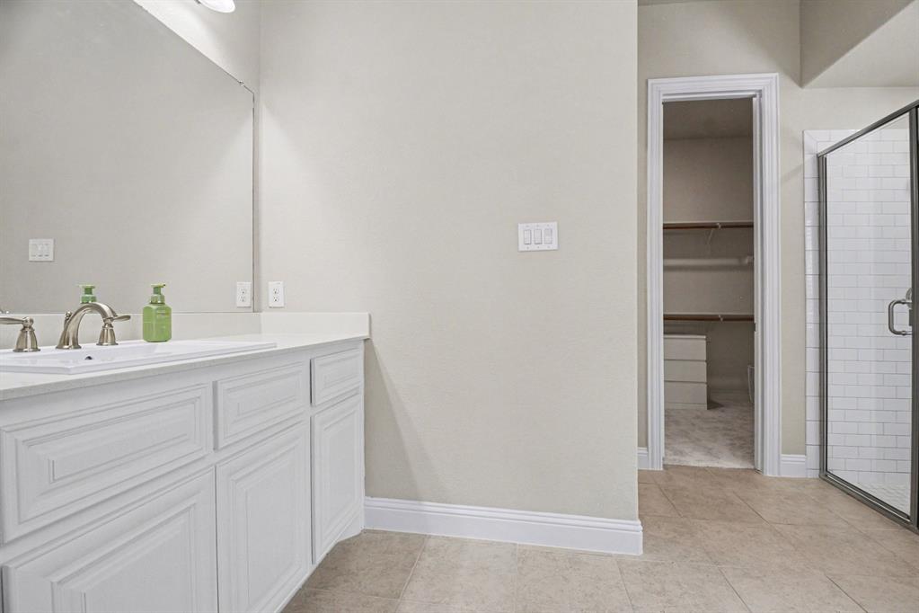 3323 Royal Ridge Drive Rockwall, TX 75087 - Photo 16 of 37 a bathroom with a sink and vanity