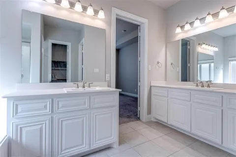 a bathroom with a sink vanity and mirror