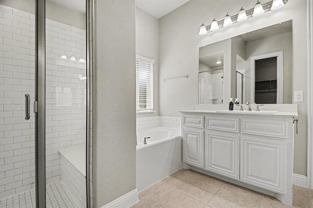3323 Royal Ridge Drive Rockwall, TX 75087 - Photo 19 of 37 a bathroom with a double vanity sink mirror and bathtub