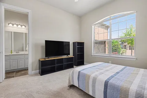 a bedroom with a bed and a television