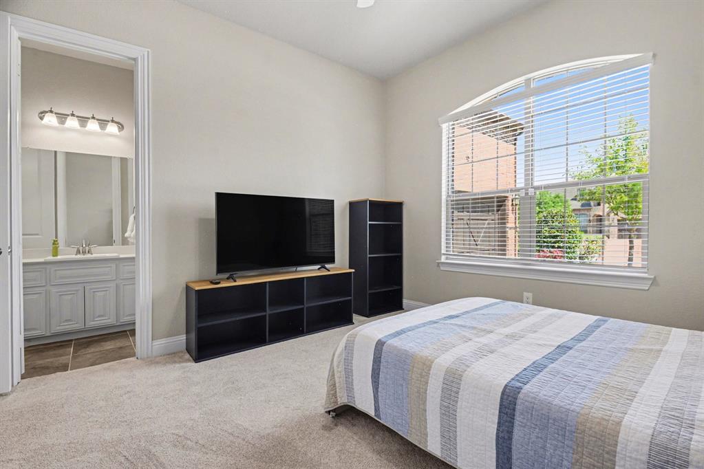 3323 Royal Ridge Drive Rockwall, TX 75087 - Photo 20 of 37 a bedroom with a bed and a television