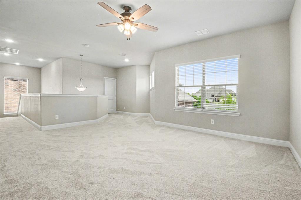 3323 Royal Ridge Drive Rockwall, TX 75087 - Photo 22 of 37 an empty room with windows and ceiling fan