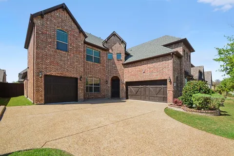 a front view of a house with yard and garage