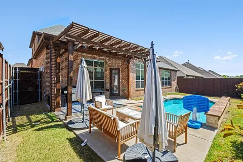 a view of a patio with table and chairs with wooden floor and fence