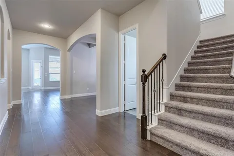 a view of an entryway with wooden floor