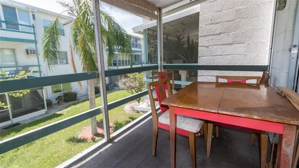 a view of balcony with a large window and wooden floor