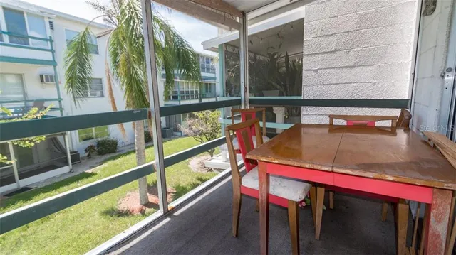 a view of balcony with a large window and wooden floor
