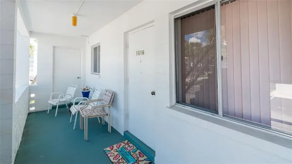 a dining room with furniture and a potted plant