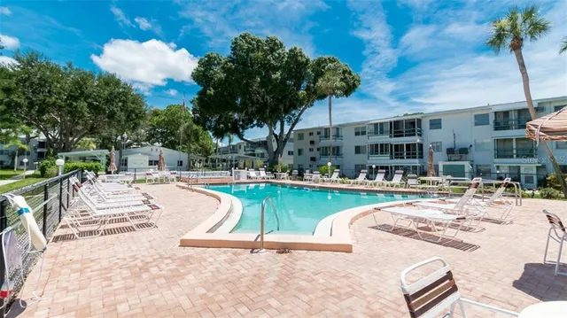 a swimming pool with outdoor seating and yard