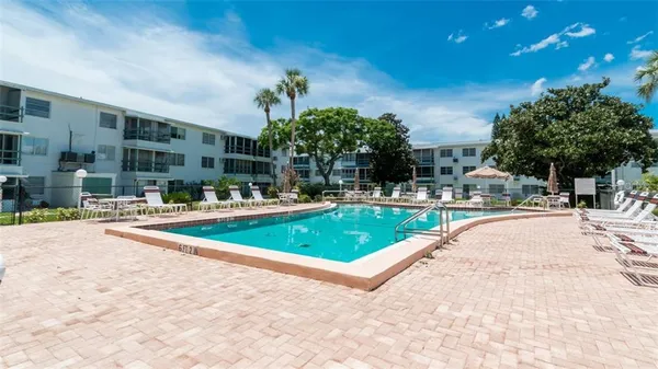 a view of a swimming pool with outdoor seating