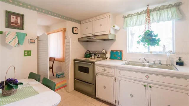 a kitchen with a sink cabinets and appliances