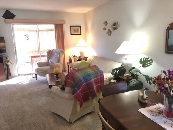 a living room with furniture and a lamp