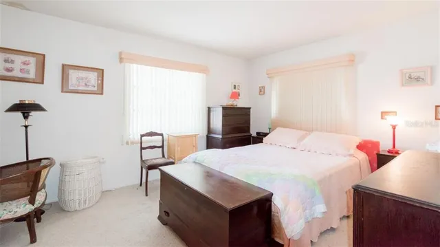 a bed room with a bed and a chair