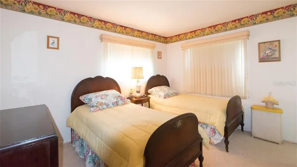 a bedroom with two beds and a window