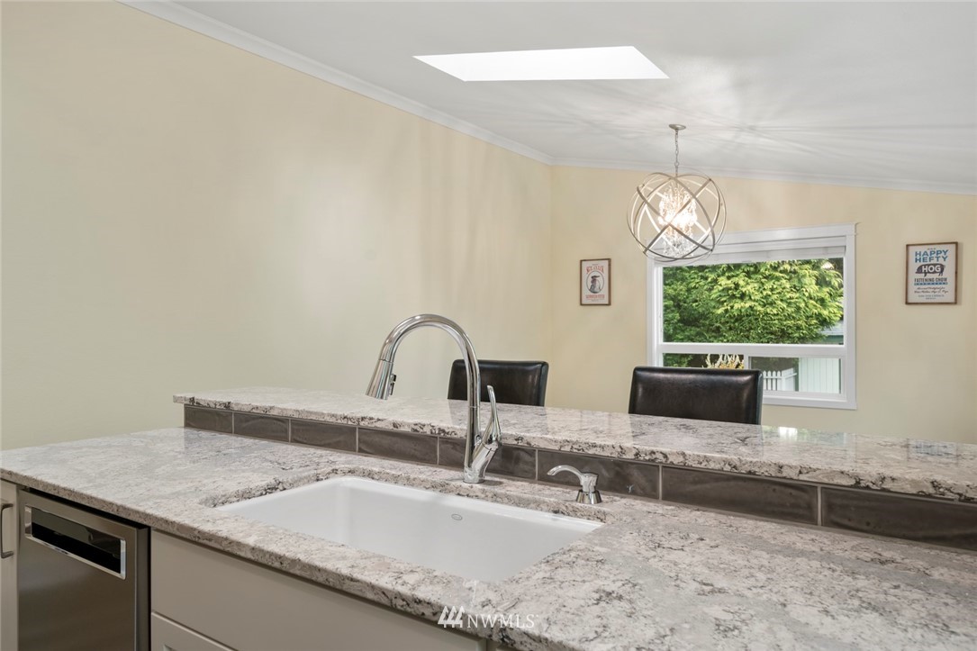 23513 22nd Avenue Southeast Bothell, WA 98021 - Photo 20 of 33 a kitchen with granite countertop a sink and a stove