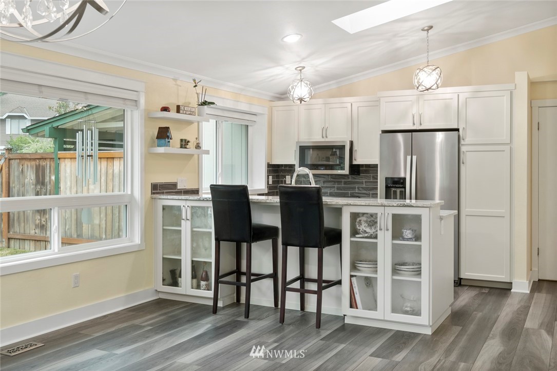 23513 22nd Avenue Southeast Bothell, WA 98021 - Photo 22 of 33 a kitchen with stainless steel appliances a refrigerator and wooden cabinets