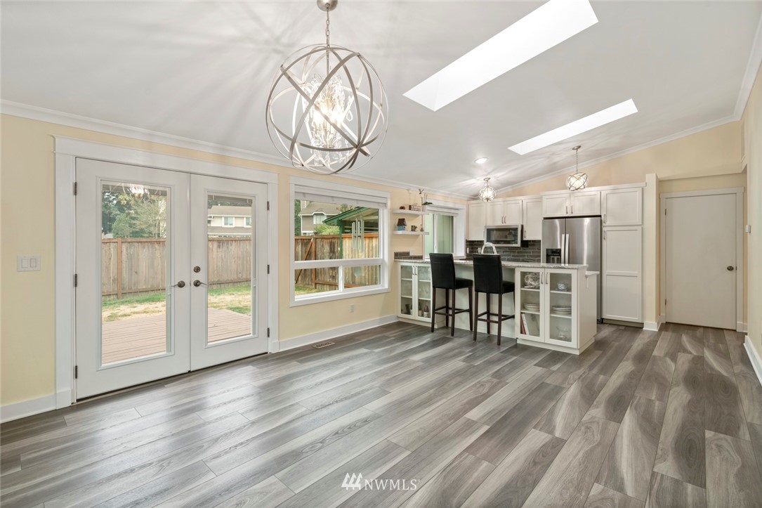 23513 22nd Avenue Southeast Bothell, WA 98021 - Photo 23 of 33 a view of a room with wooden floor fireplace and windows
